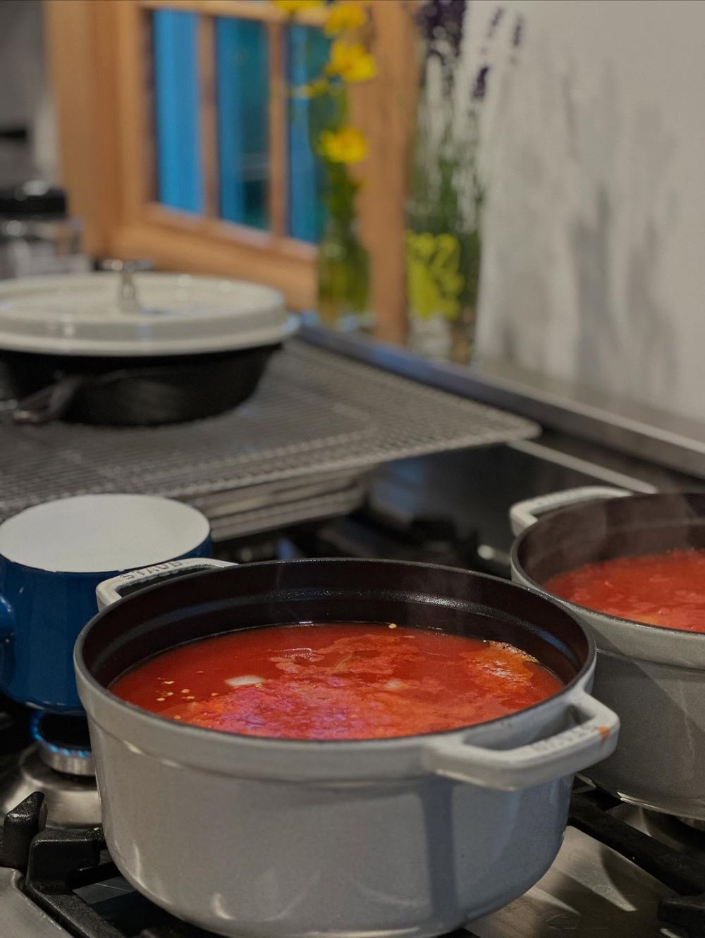 Pots of tomato bisque on the stove