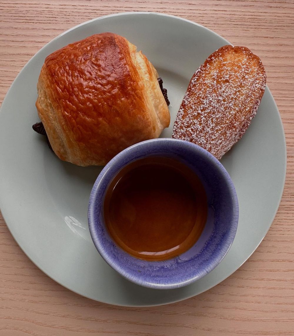 Espresso with pain au chocolat and madeleine