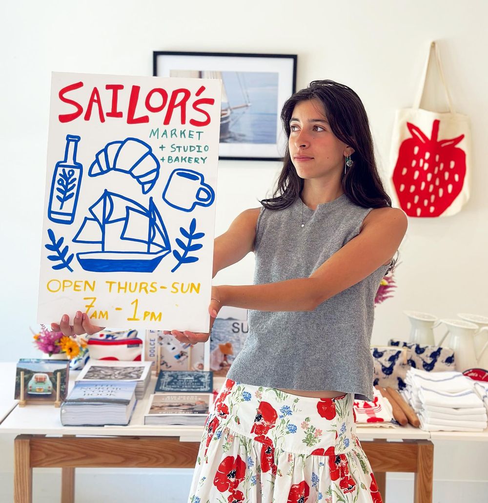 Victoria at the counter with the hand-painted Sailor's sign